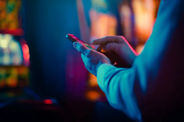 HI76 — A high-class gaming experience without limits A woman in a luxurious green gown next to an ornate roulette wheel, capturing the upscale casino mood of HI76.